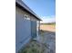 Exterior view of a home featuring gray siding, and gravel yard at 4231 E Kellogg Rd, Pahrump, NV 89061
