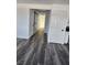 Hallway featuring gray vinyl flooring, white doors, and barn door access at 4231 E Kellogg Rd, Pahrump, NV 89061