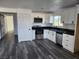 Modern kitchen with white cabinets, stainless steel appliances, and sleek black countertops at 4231 E Kellogg Rd, Pahrump, NV 89061