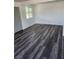 Open-concept living space featuring gray vinyl flooring and a bright window at 4231 E Kellogg Rd, Pahrump, NV 89061