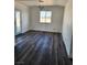 Living room with modern lighting and vinyl flooring; bright view through backyard door at 4231 E Kellogg Rd, Pahrump, NV 89061