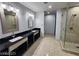 Bathroom with double sinks, dark countertops, tile flooring and frameless glass shower enclosure at 4525 Dean Martin Dr # 1507, Las Vegas, NV 89103