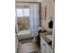 Bathroom includes a granite vanity, toilet, combination tub and shower, window and wall art at 4525 Fulton Pl, Las Vegas, NV 89107