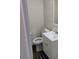 Half bathroom includes a toilet and vanity with drawers for storage, a sink, and a chrome faucet at 4525 Fulton Pl, Las Vegas, NV 89107