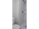 This is a bathroom with a toilet and a shower with shelves for storage and chrome hardware at 4525 Fulton Pl, Las Vegas, NV 89107