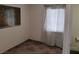Bedroom featuring neutral walls, patterned tile flooring, a light gray area rug, and window with semi-sheer curtains at 4525 Fulton Pl, Las Vegas, NV 89107