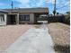 Long driveway leading to covered parking with desert landscaping and a privacy fence at 4525 Fulton Pl, Las Vegas, NV 89107
