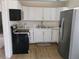 Bright kitchen featuring white cabinets, quartz countertops, and stainless steel appliances at 4525 Fulton Pl, Las Vegas, NV 89107