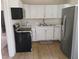 Updated kitchen with white cabinets, quartz countertops, stainless steel refrigerator at 4525 Fulton Pl, Las Vegas, NV 89107