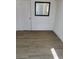 Room featuring modern vinyl flooring and a door-sized mirror on the wall at 4525 Fulton Pl, Las Vegas, NV 89107