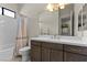 Bathroom featuring a dark vanity with white countertop and tub with shower curtain at 47 Garibaldi Way, Henderson, NV 89011