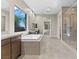 This primary bathroom has a soaking tub, large vanity, and glass-enclosed shower at 47 Garibaldi Way, Henderson, NV 89011