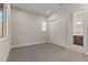 Bedroom with neutral carpet, window, and ensuite bathroom access at 47 Garibaldi Way, Henderson, NV 89011