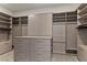 This walk-in closet provides generous storage space with custom shelving and drawers at 47 Garibaldi Way, Henderson, NV 89011