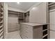 Walk-in closet with custom shelving and a center island at 47 Garibaldi Way, Henderson, NV 89011