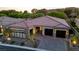 Elegant home featuring a manicured lawn, desert landscaping, and dark two-car garage at 47 Garibaldi Way, Henderson, NV 89011