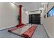 Spacious garage featuring a car lift and modern door at 47 Garibaldi Way, Henderson, NV 89011
