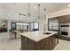 Gourmet kitchen features a marble island, stainless steel appliances, and modern lighting fixtures at 47 Garibaldi Way, Henderson, NV 89011