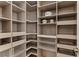 Organized walk-in pantry featuring custom shelving, pull-out drawers, and ample storage space at 47 Garibaldi Way, Henderson, NV 89011