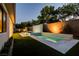 Beautiful swimming pool with fountain feature in a landscaped backyard with artificial grass at 47 Garibaldi Way, Henderson, NV 89011
