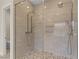 Walk-in shower showcasing dual shower heads and beautiful pebble flooring at 47 Garibaldi Way, Henderson, NV 89011