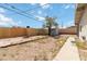 Fenced backyard featuring grass and a concrete walkway at 49 Constitution Ave, Henderson, NV 89015