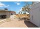 Backyard view with covered patio, storage shed, and wood fence at 49 Constitution Ave, Henderson, NV 89015