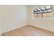 Bedroom with wood-look floors, neutral walls and window overlooking backyard at 49 Constitution Ave, Henderson, NV 89015