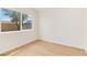 An empty bedroom features wood-look flooring, neutral walls, and a window view at 49 Constitution Ave, Henderson, NV 89015