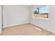 An empty bedroom features wood-look flooring, neutral walls, and a window view at 49 Constitution Ave, Henderson, NV 89015