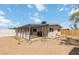 Exterior view of home with covered patio and wood fence in the backyard at 49 Constitution Ave, Henderson, NV 89015