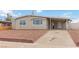 Charming single-story home with a covered parking area and low-maintenance landscaping at 49 Constitution Ave, Henderson, NV 89015