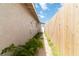 View of the side of the house with wood fence and access door to the backyard at 49 Constitution Ave, Henderson, NV 89015