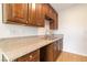 Close-up of the kitchen with granite counters, wood cabinets and a stainless steel sink at 49 Constitution Ave, Henderson, NV 89015