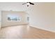 Bright living room with light wood floors and a large window at 49 Constitution Ave, Henderson, NV 89015