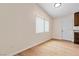 Bright living room featuring wood-look floors, neutral walls, and a window with blinds at 49 Constitution Ave, Henderson, NV 89015