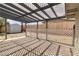 View of the covered patio with lattice and adjacent backyard with storage shed and wood fence at 49 Constitution Ave, Henderson, NV 89015