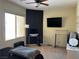 Bedroom with natural light, ceiling fan, and black accent wall with television and desk at 5043 Gable Crest Ct, Las Vegas, NV 89141