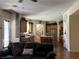 Inviting living room flows into a spacious kitchen with a central island and stainless steel refrigerator at 5043 Gable Crest Ct, Las Vegas, NV 89141
