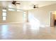 Large bedroom with tile flooring, large windows, and a ceiling fan at 5451 Fernwood Ct, Pahrump, NV 89061