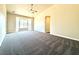 Cozy bedroom with plush carpet, a bay window, and a ceiling fan at 5451 Fernwood Ct, Pahrump, NV 89061