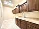 Functional laundry room with wood cabinetry and a sink at 5451 Fernwood Ct, Pahrump, NV 89061
