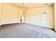 Bright living room with carpet flooring, high ceilings, and door to the backyard at 5451 Fernwood Ct, Pahrump, NV 89061