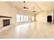 Expansive living room with a fireplace, large windows, and modern ceiling fans at 5451 Fernwood Ct, Pahrump, NV 89061