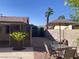 Relaxing backyard space with covered patio, outdoor dining area, and beautiful palm trees at 5821 Santa Catalina Ave, Las Vegas, NV 89108
