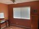 Welcoming bedroom featuring a window with blinds, desk, and storage cabinet at 5821 Santa Catalina Ave, Las Vegas, NV 89108
