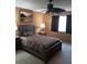 Comfortable bedroom with a ceiling fan, patterned bedding, and natural light from the window at 5821 Santa Catalina Ave, Las Vegas, NV 89108