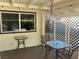 Charming covered patio with lattice wall, outdoor dining furniture, and ambient string lights at 5821 Santa Catalina Ave, Las Vegas, NV 89108