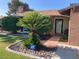 Welcoming front entrance with a secure ADT system, a beautiful cycad tree, and lush greenery at 5821 Santa Catalina Ave, Las Vegas, NV 89108