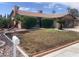 Charming single-story home featuring desert landscaping with a fresh lawn, palm trees, and a brick exterior at 5821 Santa Catalina Ave, Las Vegas, NV 89108